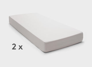 Adjustable bed fitted sheets by It-Fits in neutral Beige, displayed on a split mattress with deep pockets against a simple backdrop.