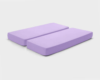 Stretchy, easy-care fitted sheets in Lavender Purple by It-Fits, shown on a split king mattress against a plain background
