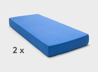 Adjustable bed sheets by It-Fits in Royal Blue, shown on a dual queen mattress with deep pockets against a plain background.