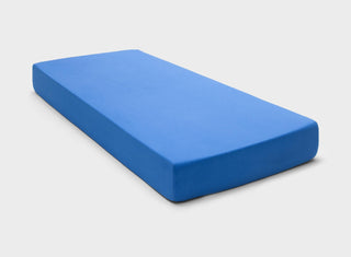Breathable 100% cotton jersey fitted sheet in Royal Blue by It-Fits, snugly covering a mattress with deep pockets against a plain background.