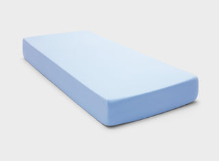 Skin-safe and eco-friendly fitted bed sheet in light blue colour by It-Fits, showing a perfect fit with deep pockets on a long single mattress.