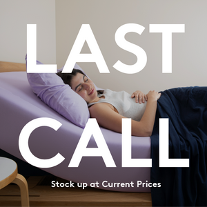 Woman relaxing on bed with purple jersey fitted sheet, text overlay reads “LAST CALL – Stock up at Current Prices