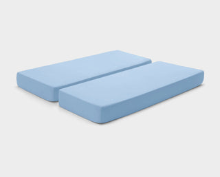 It-Fits fitted sheets for adjustable beds in Sky Blue, shown on a dual king mattress with deep pockets against a plain background.