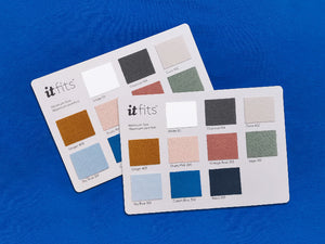 two pieces overlaying color cards showcasing a wide range of material and colors, displayed on a royal blue fitted sheet background for fitted sheets or sheet sets