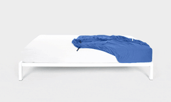 Demonstrating the action of fitting the It-Fits Jersey Fitted Sheet in royal blue onto a white bed, showcasing how easy bed making, breathable 100% Australian cotton jersey sheet on a white plain background