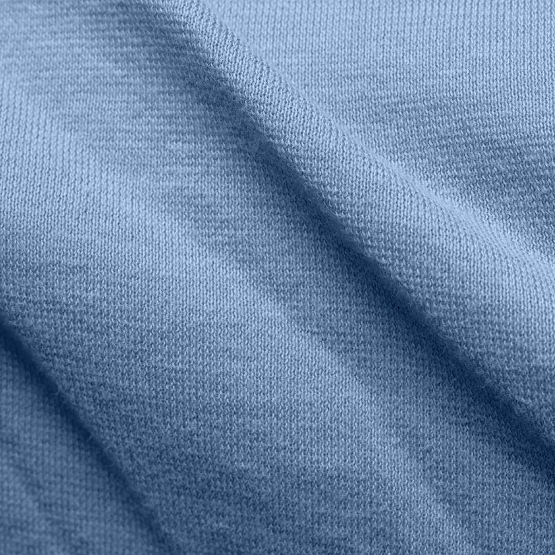 Close-up of knitted jersey fabric structure showing the flexible knit used in breathable bed sheets