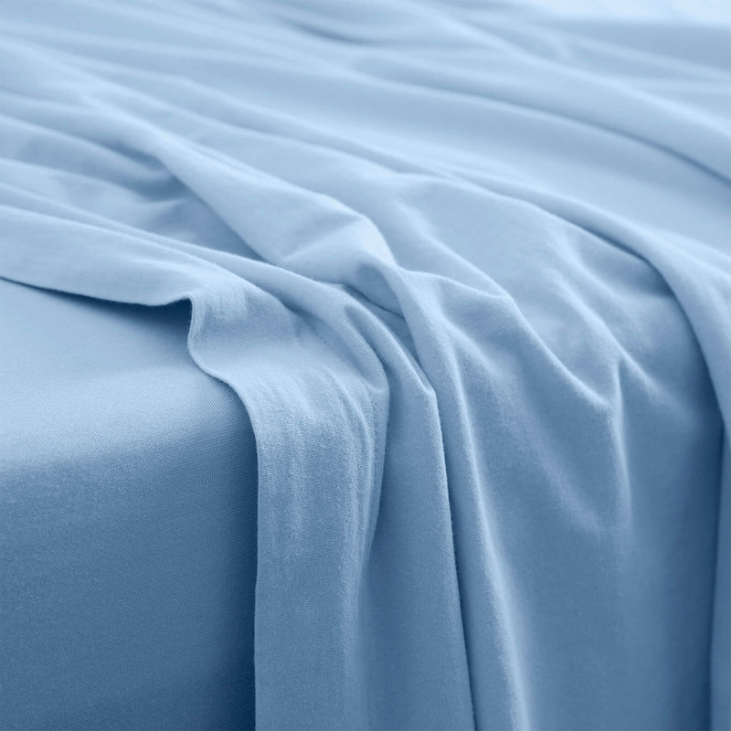It-Fits® flat sheet in sky blue jersey cotton draped softly, showing the natural fall and gentle drape of the fabric