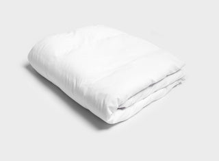 White doona cover by It-Fits with a high-quality zipper and handy connection hoops to prevent runaway corners, folded and on plain background